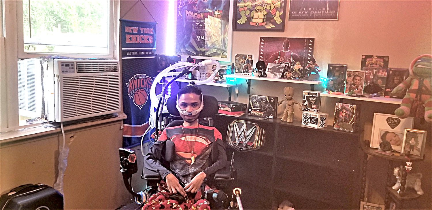 Matthew Roopchandsingh sits in front of his video game memorabilia.